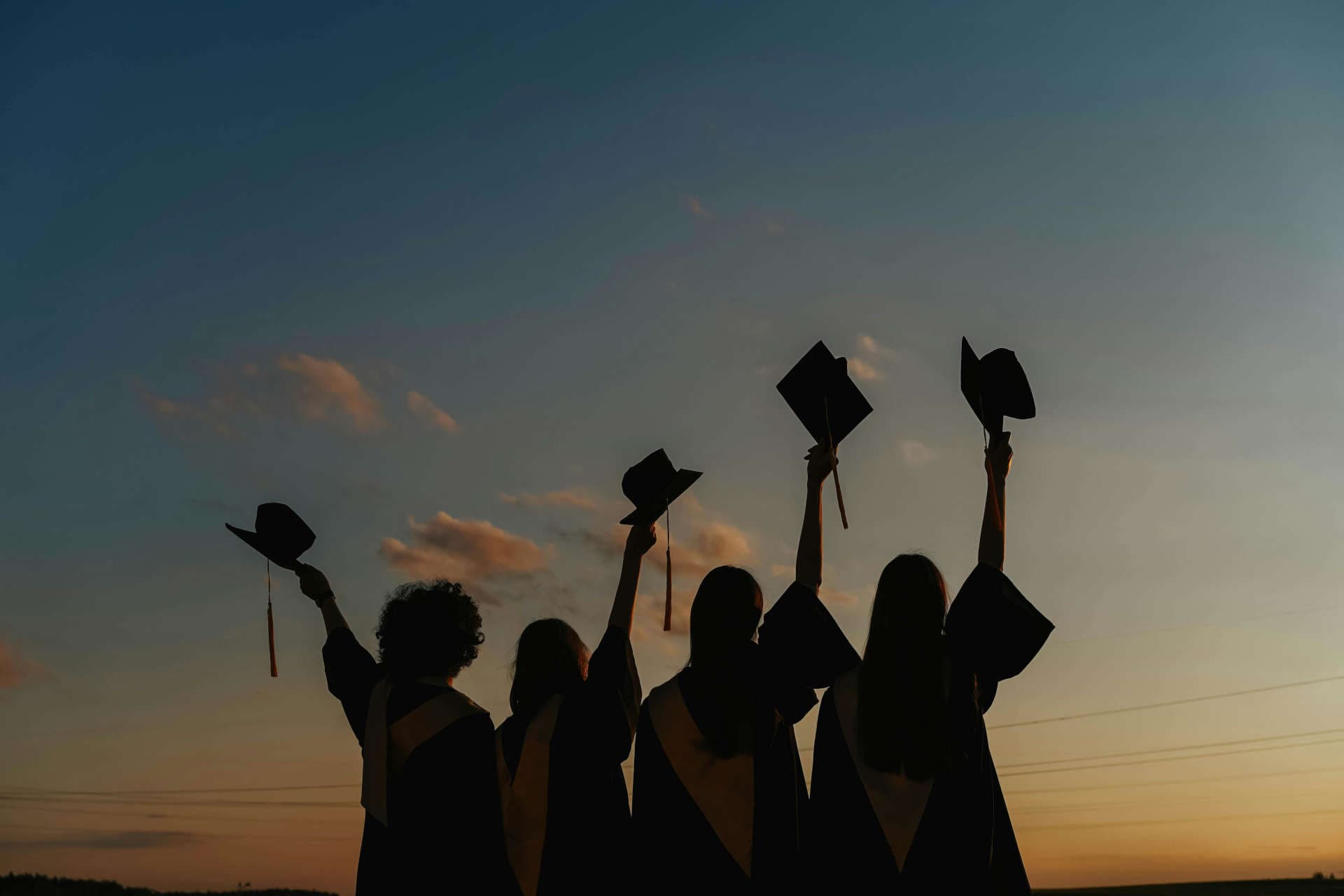 A picture of graduates tossing their caps in the air